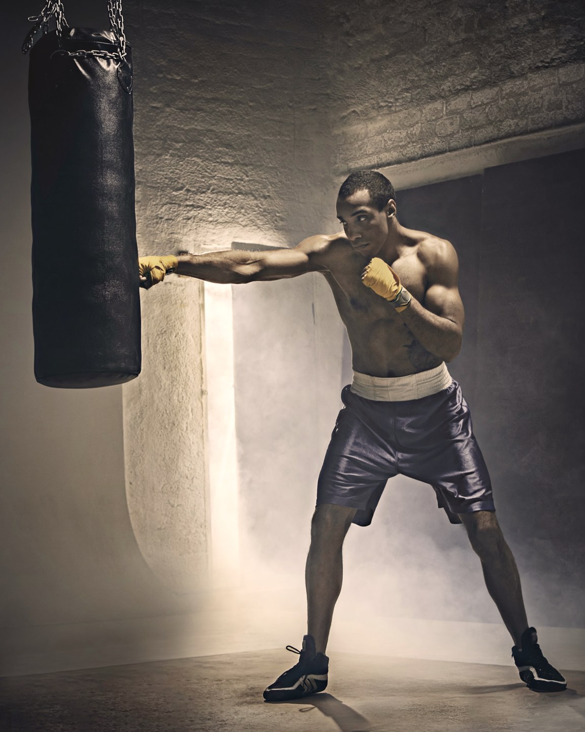 A boxer mid-jab on a heavy bag